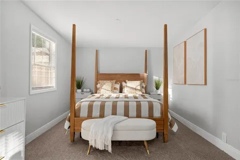 a living room with a bed furniture and a window