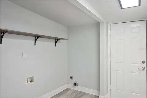 a backyard of a house with wooden fence and trees