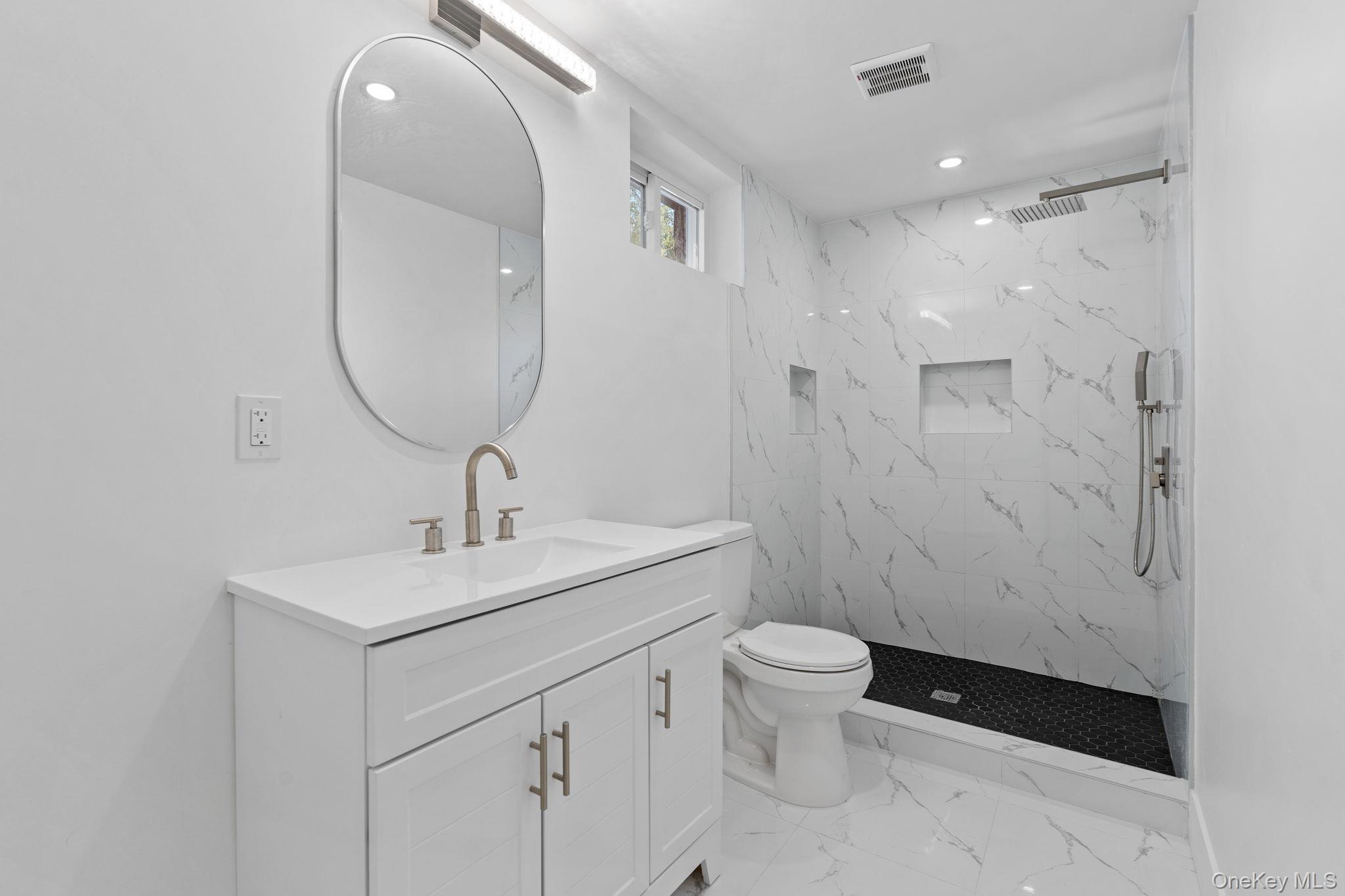 52 Rudolph Road Modena, NY 12548 - Photo 32 of 49 Full bathroom with vanity, a marble finish shower, light marble finish floors, and recessed lighting