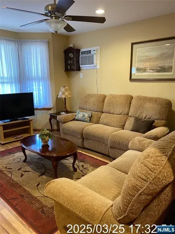 a bedroom with a bed and a view of living room