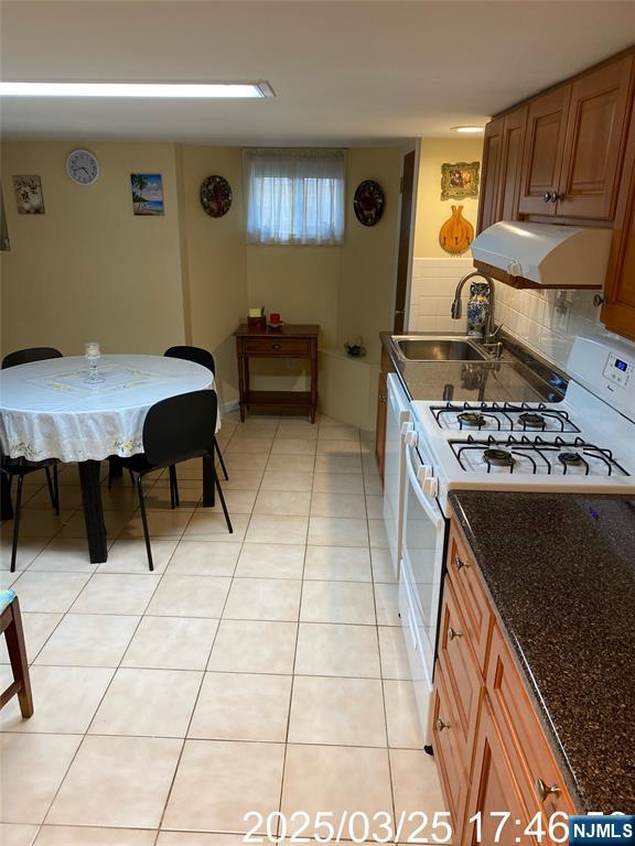 81 Waydell Street Newark, NJ 07105 - Photo 21 of 29 a kitchen with stainless steel appliances kitchen island granite countertop a stove a sink and a refrigerator