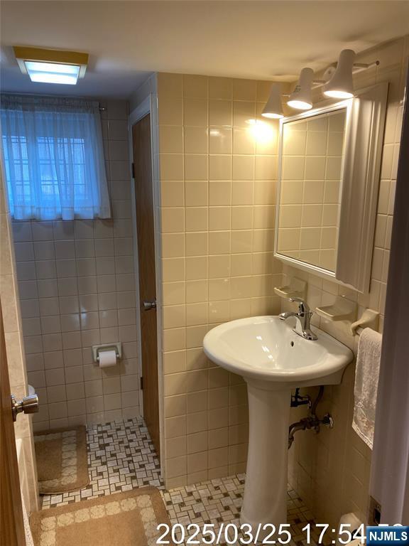 81 Waydell Street Newark, NJ 07105 - Photo 22 of 29 a bathroom with a sink a toilet and shower