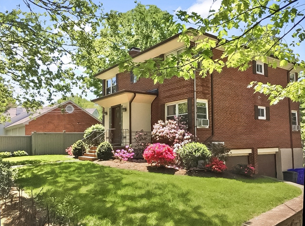 a front view of a house with garden