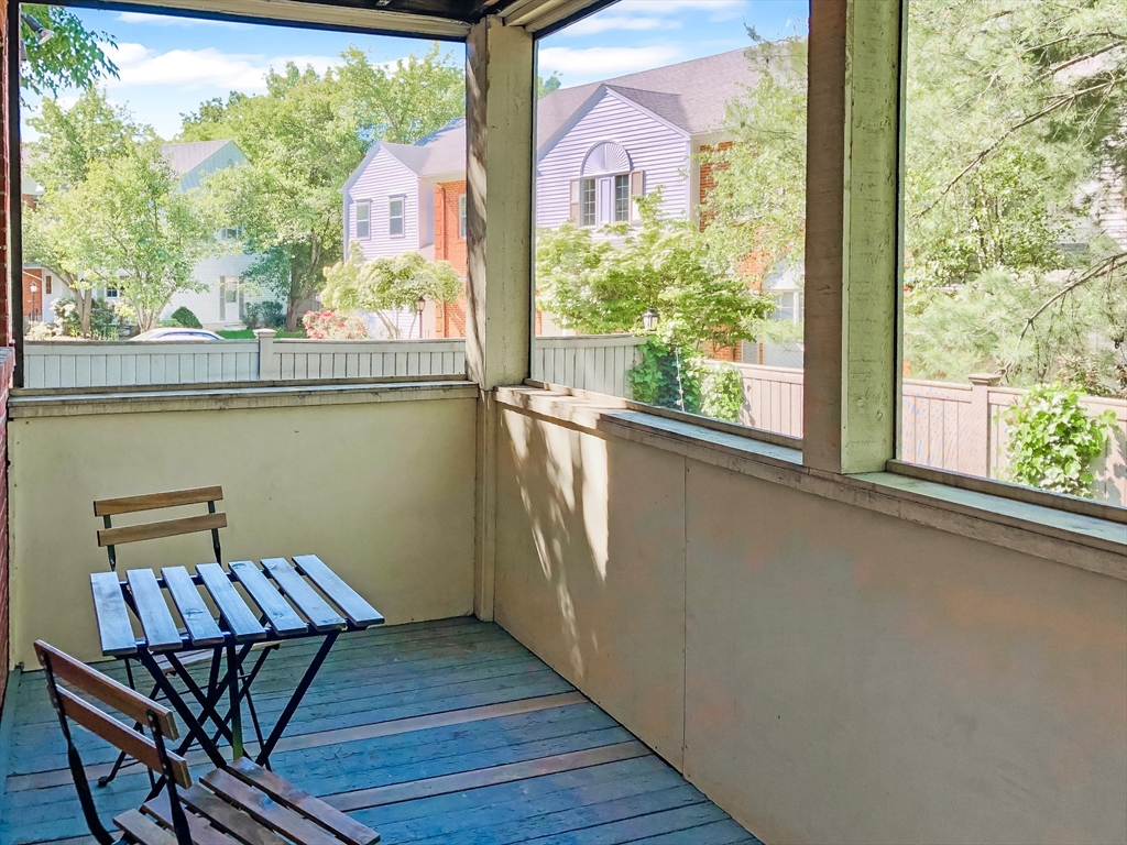 675 Chestnut Hill Avenue Brookline, MA 02445 - Photo 11 of 23 a view of a balcony with chairs and wooden floor