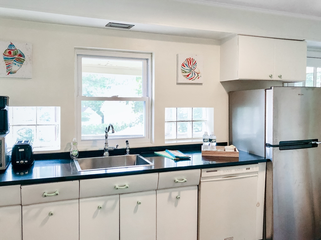 675 Chestnut Hill Avenue Brookline, MA 02445 - Photo 15 of 23 a kitchen with stainless steel appliances a sink a window and refrigerator