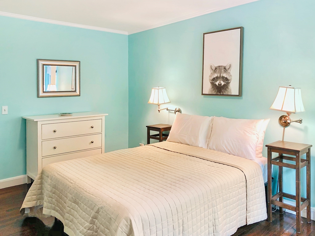 675 Chestnut Hill Avenue Brookline, MA 02445 - Photo 17 of 23 a bedroom with a bed and a lamp on dresser