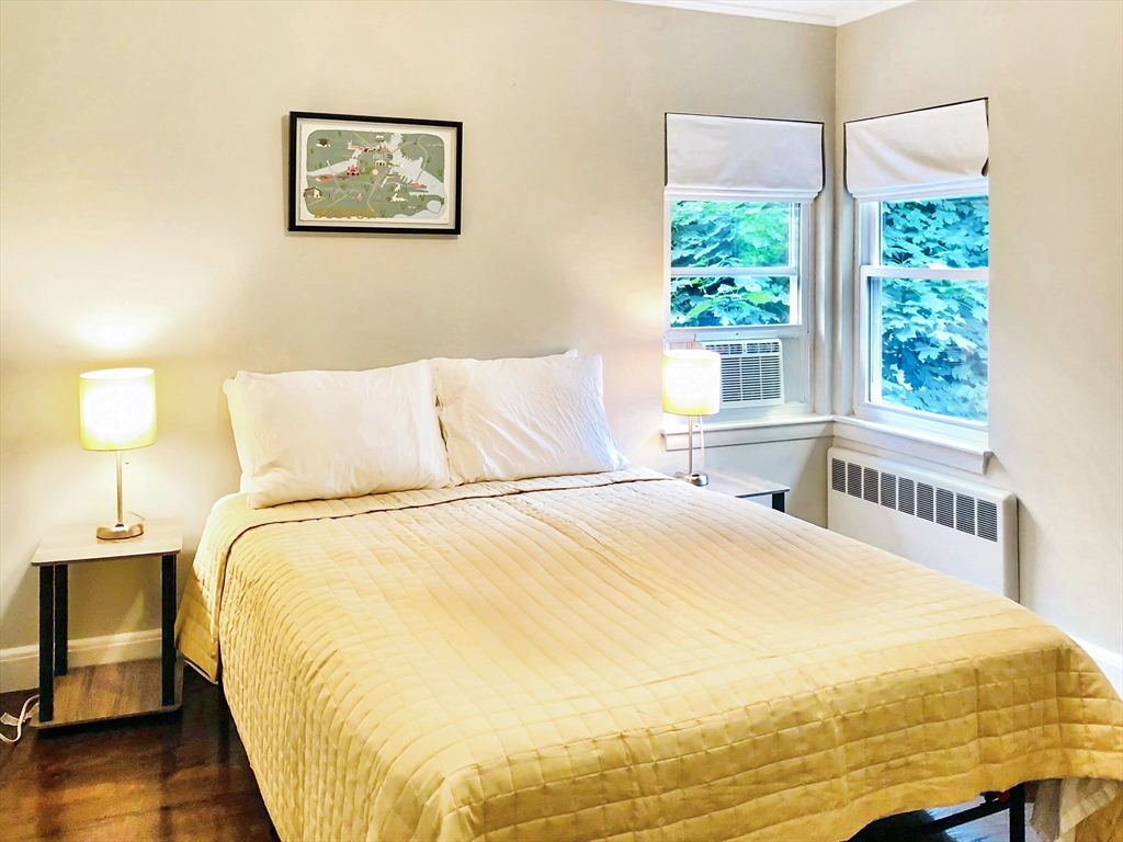 675 Chestnut Hill Avenue Brookline, MA 02445 - Photo 18 of 23 a large bed sitting in a bedroom next to a window