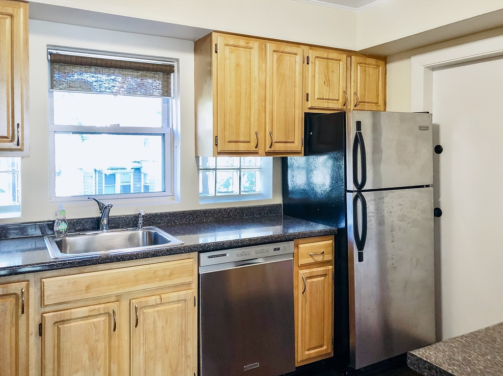 675 Chestnut Hill Avenue Brookline, MA 02445 - Photo 5 of 23 a kitchen with stainless steel appliances granite countertop a refrigerator a sink and a cabinets