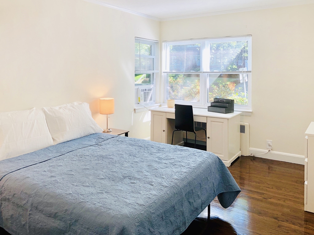 675 Chestnut Hill Avenue Brookline, MA 02445 - Photo 7 of 23 a bedroom with a bed and a window