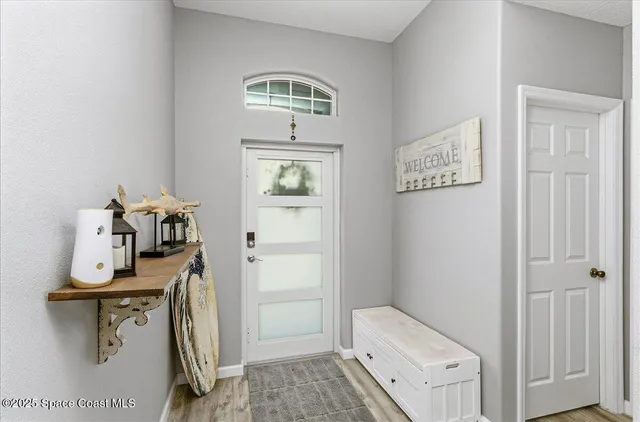 a kitchen with a table chairs and a refrigerator
