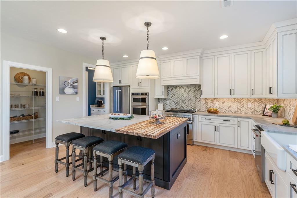 103 Maggie Drive Eighty Four, PA 15330 - Photo 8 of 23 a kitchen with center island table and chairs in it