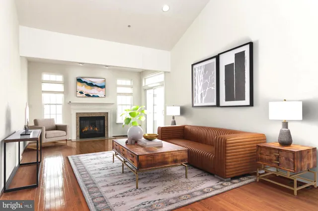 a living room with furniture a fireplace and a table