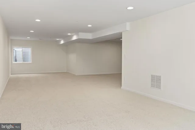 an empty room with a ceiling fan