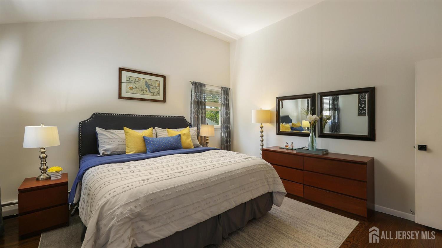 47 Miliken Road Colonia, NJ 07067 - Photo 26 of 40 a bedroom with a bed and a large mirror on dresser