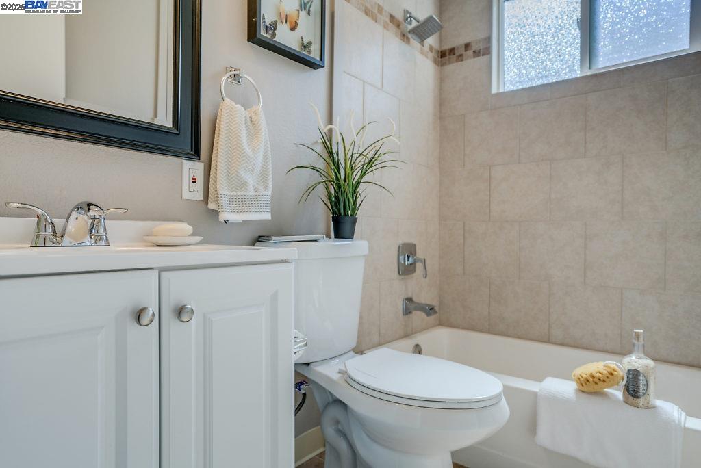 2093 Mt Diablo Street Concord, CA 94520 - Photo 12 of 16 a bathroom with a sink a toilet and a mirror
