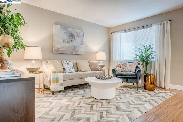 a living room with furniture and a painting on the wall