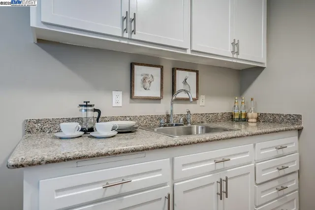 a view of a dining room with furniture and a potted plant
