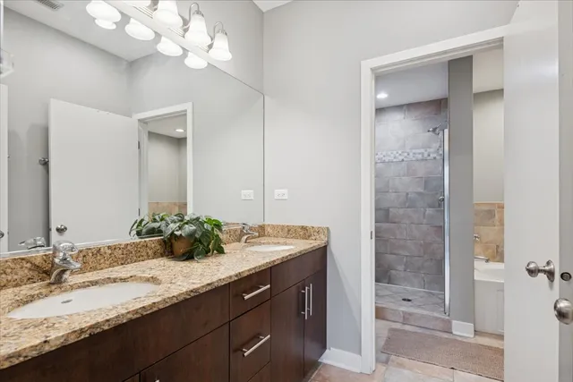 a bathroom with a sink double vanity and a mirror