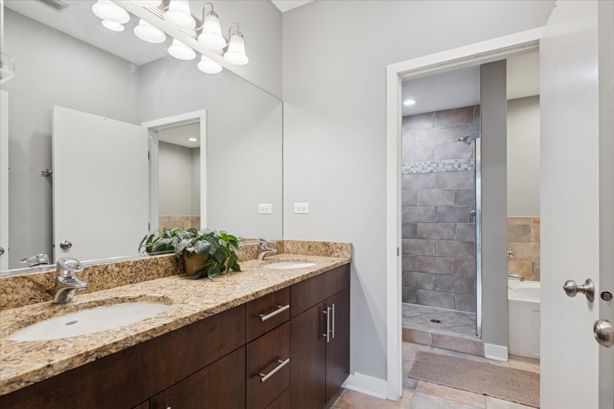 1234 North Milwaukee Avenue, Unit 3 Chicago, IL 60622 - Photo 11 of 16 a bathroom with a sink double vanity and a mirror