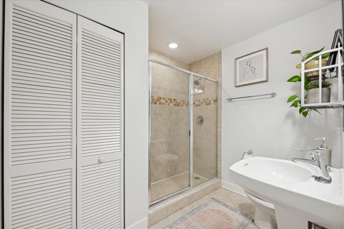 1234 North Milwaukee Avenue, Unit 3 Chicago, IL 60622 - Photo 14 of 16 a bathroom with a sink and a shower