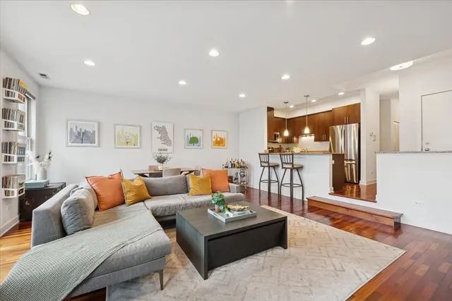 a living room with furniture and kitchen view