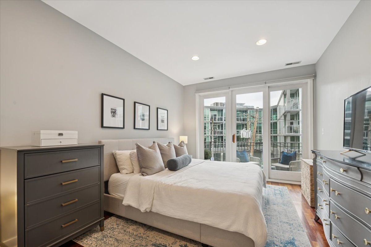 1234 North Milwaukee Avenue, Unit 3 Chicago, IL 60622 - Photo 9 of 16 a bedroom with a large bed and a window