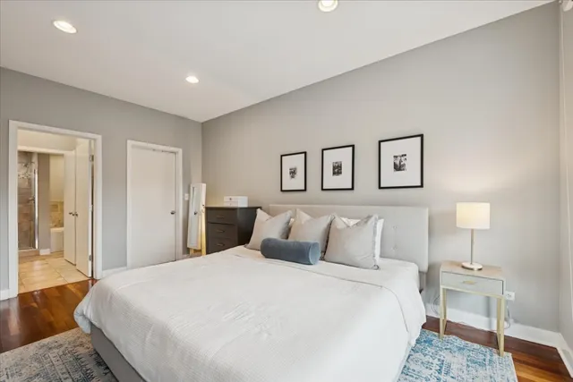 a bedroom with a large bed and a lamp