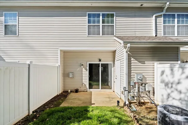 a view of a backyard with plants and a patio