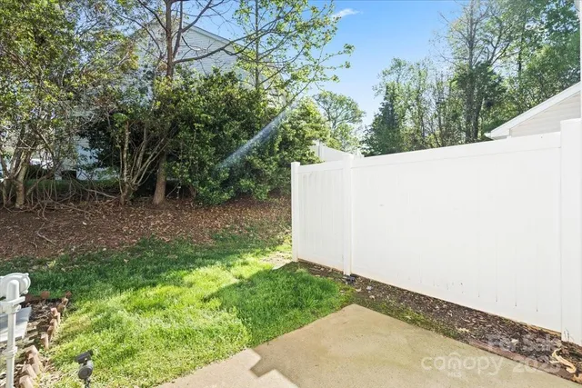 a backyard of a house with plants and lake view