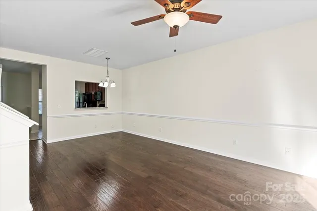a living room with furniture a chandelier and a dining room