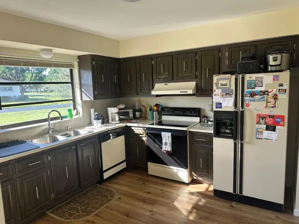 a bathroom with a granite countertop sink a toilet and shower