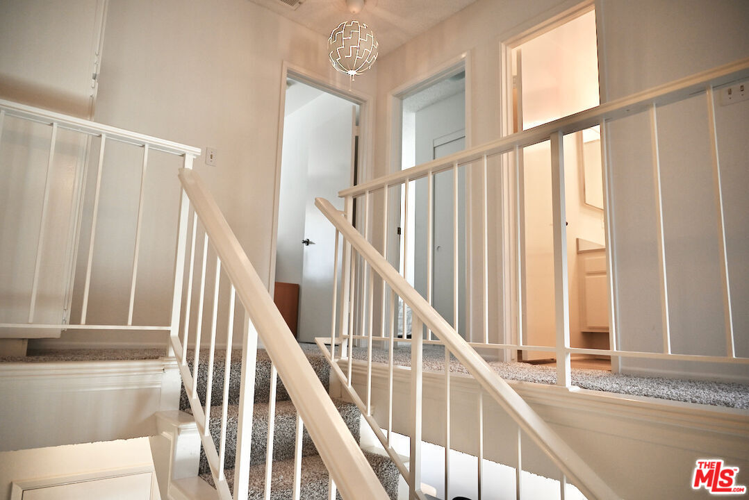 19355 Sherman Way, Unit 42 Reseda, CA 91335 - Photo 14 of 41 a view of staircase with railing and white walls