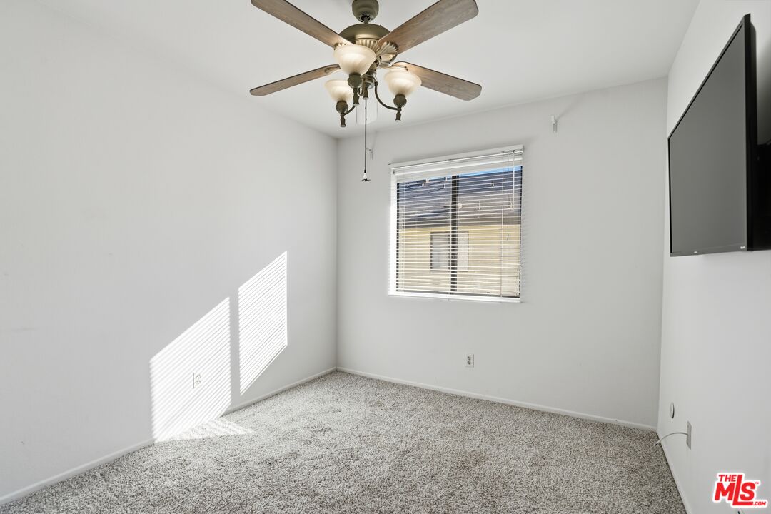 19355 Sherman Way, Unit 42 Reseda, CA 91335 - Photo 17 of 41 a view of a livingroom with a ceiling fan and window