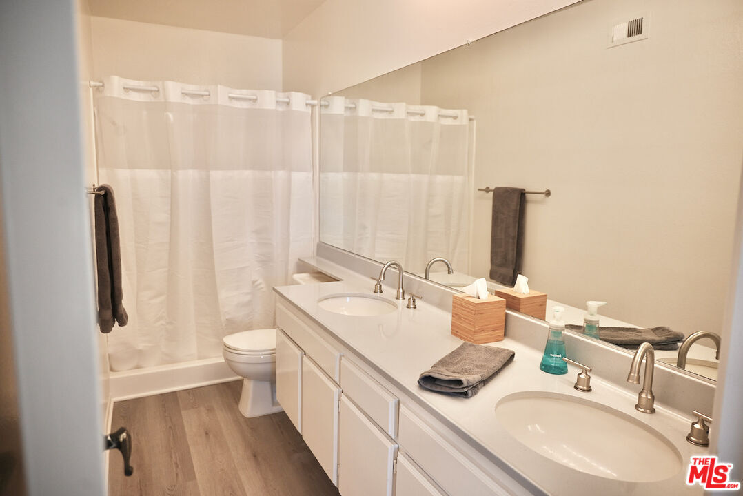 19355 Sherman Way, Unit 42 Reseda, CA 91335 - Photo 19 of 41 a bathroom with a double vanity sink toilet and shower