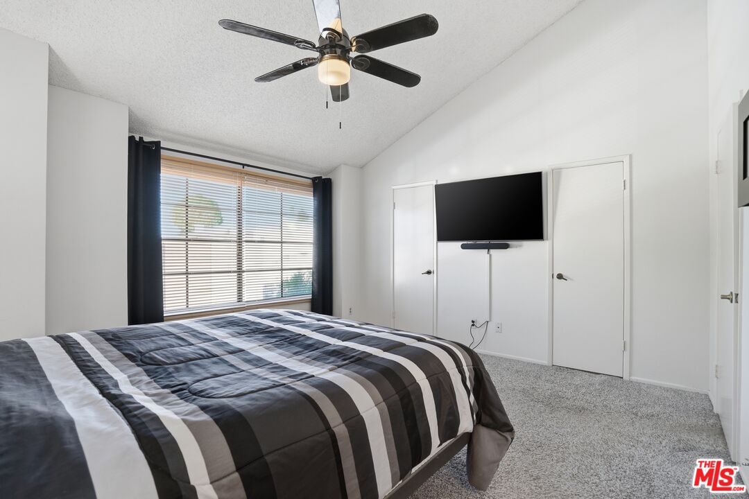 19355 Sherman Way, Unit 42 Reseda, CA 91335 - Photo 21 of 41 a bedroom with a large bed and a flat screen tv