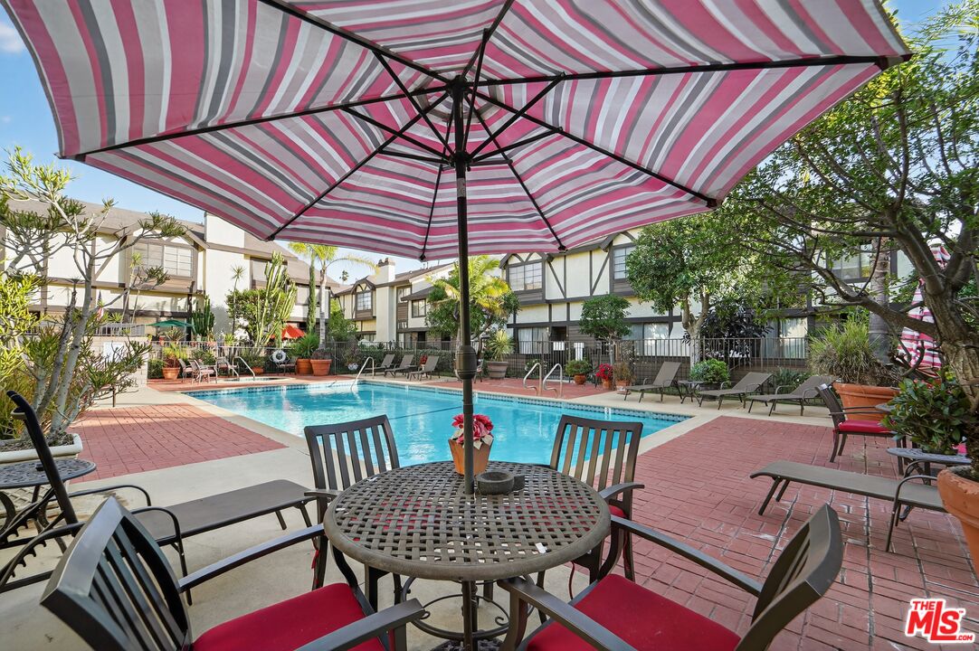 19355 Sherman Way, Unit 42 Reseda, CA 91335 - Photo 26 of 41 a patio with a patio table and chairs