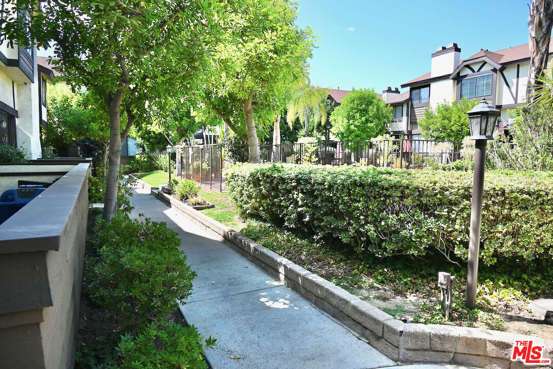 19355 Sherman Way, Unit 42 Reseda, CA 91335 - Photo 32 of 41 a view of a garden with pathway
