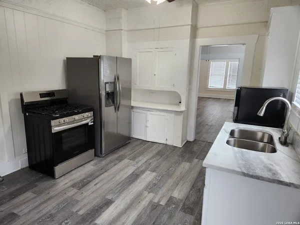 a kitchen with a refrigerator stove and sink