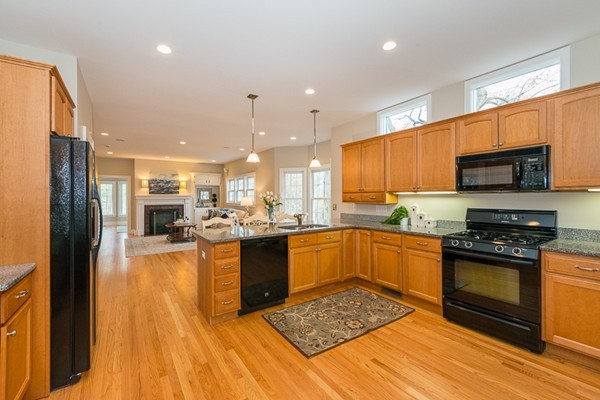 11 Oakland Street Lexington, MA 02420 - Photo 11 of 30 a kitchen with stainless steel appliances granite countertop a stove top oven a sink dishwasher a refrigerator and a dining table with wooden floor