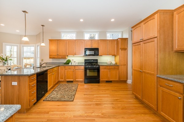 11 Oakland Street Lexington, MA 02420 - Photo 12 of 30 a kitchen with granite countertop a refrigerator stove top oven and sink