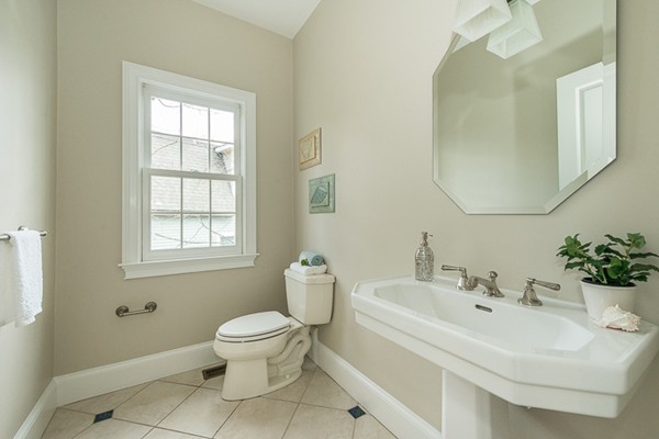 11 Oakland Street Lexington, MA 02420 - Photo 13 of 30 a white toilet sitting next to a bathroom sink