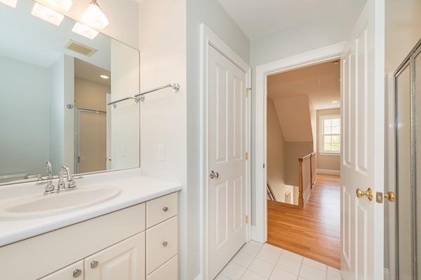 11 Oakland Street Lexington, MA 02420 - Photo 25 of 30 a bathroom with a shower sink and mirror