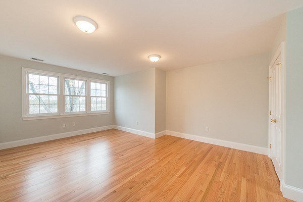 11 Oakland Street Lexington, MA 02420 - Photo 27 of 30 wooden floor in an empty room with a window