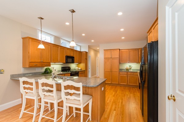 11 Oakland Street Lexington, MA 02420 - Photo 10 of 30 a kitchen with stainless steel appliances kitchen island granite countertop a stove a sink and a refrigerator
