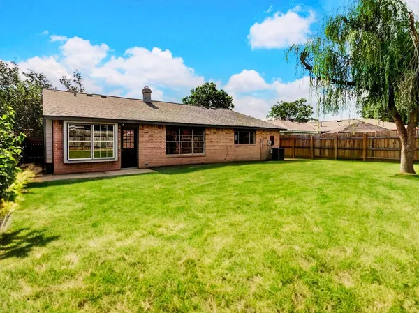 a view of a house with a yard and sitting area