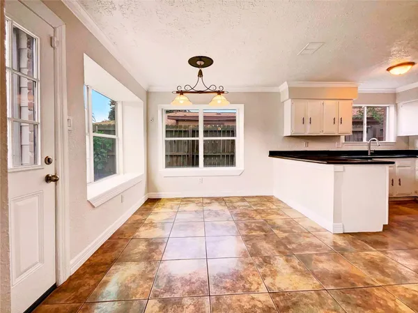 a view of a kitchen with granite countertop a sink and a window