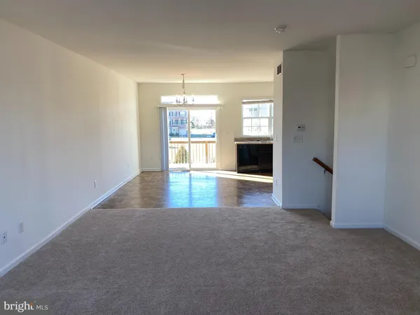 an empty room with windows and fireplace