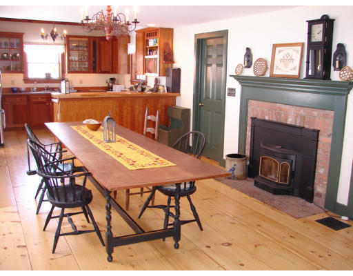 6 Adams Road North Brookfield, MA 01535 - Photo 5 of 19 a view of a dining room with furniture and a fireplace
