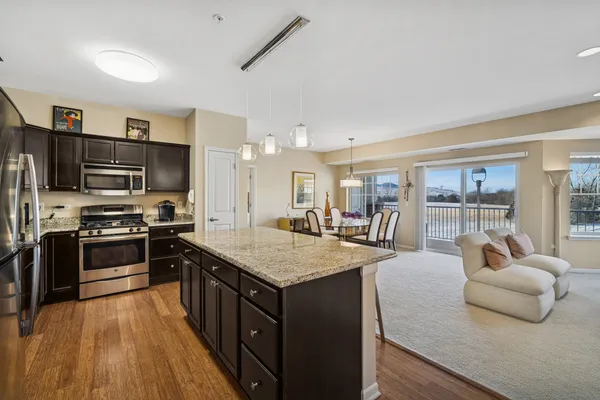 a large kitchen with stainless steel appliances granite countertop a large counter top and stove