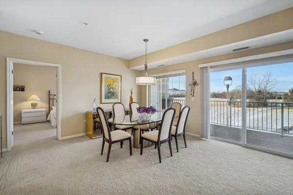a dining room with furniture and window